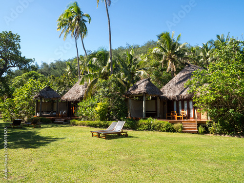 South Pacific Tropical Island Bure Bungalow Deck with Day Bed Looking over Garden, Oceans and Over Water Bure in Fiji photo
