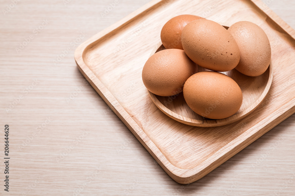 Close-up view of chicken eggs on wooden table background Close-up view of chicken eggs on wooden table background