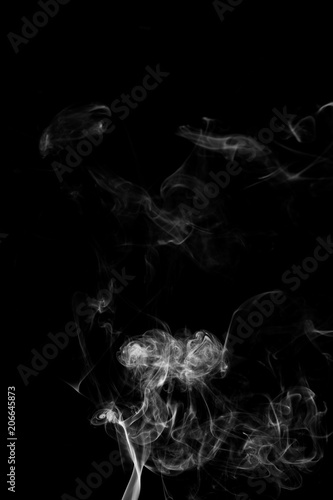 Movement of white smoke isolated on black background. photo