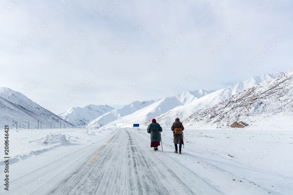 two pilgrims on snow area plateau