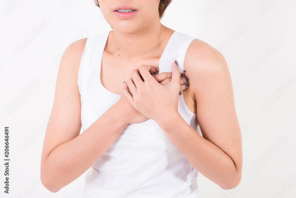 Heart attack. Beautiful young Asian woman feeling sharp strong pain in chest.   Isolated on white background. Studio lighting. Concept for healthy and medical