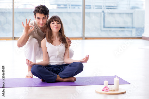 Personal coach helping during yoga session