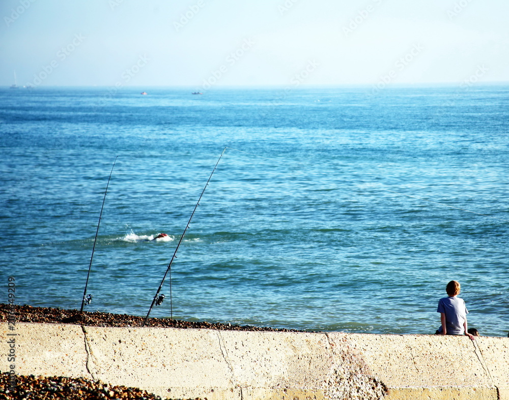 Children sit on the beach scene.