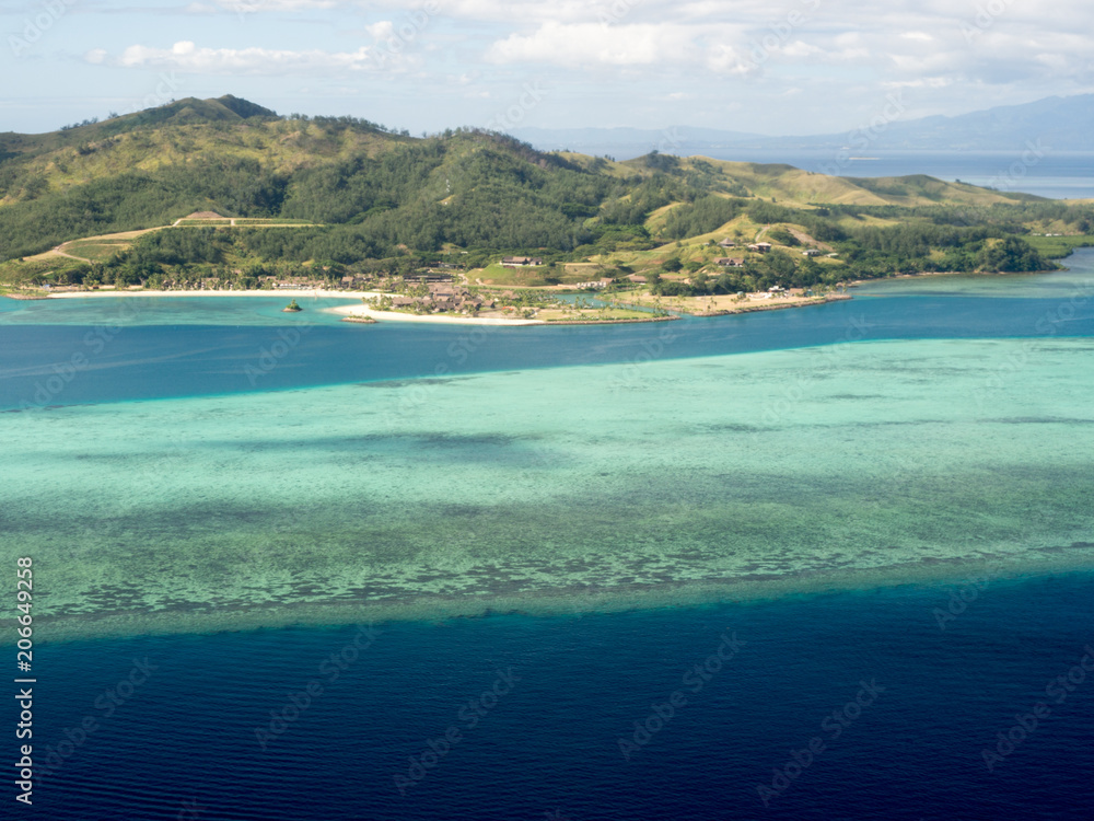 Aerial View over Colourful Deep Blue Tropical Island Ocean Sea Reef