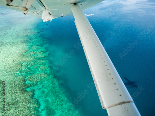Aerial View over Tropical Island Ocean Sea Reef from Inside Seaplane