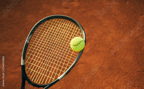 Close up of tennis ball on the clay court © yossarian6