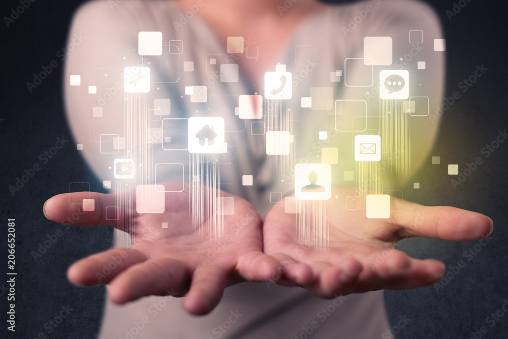 Blue social application icons in the hands of young casual businesswoman Blue social application icons in the hands of young casual businesswoman
