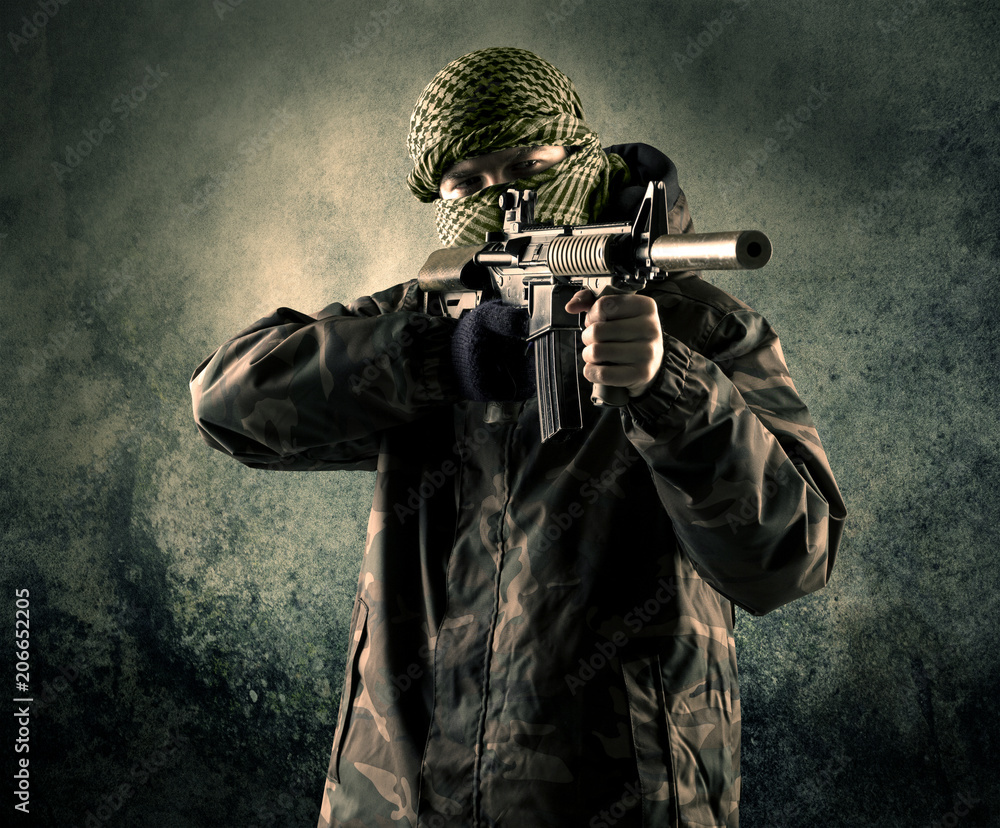 Portrait of a heavily armed masked soldier with grungy background concept Portrait of a heavily armed masked soldier with grungy background concept