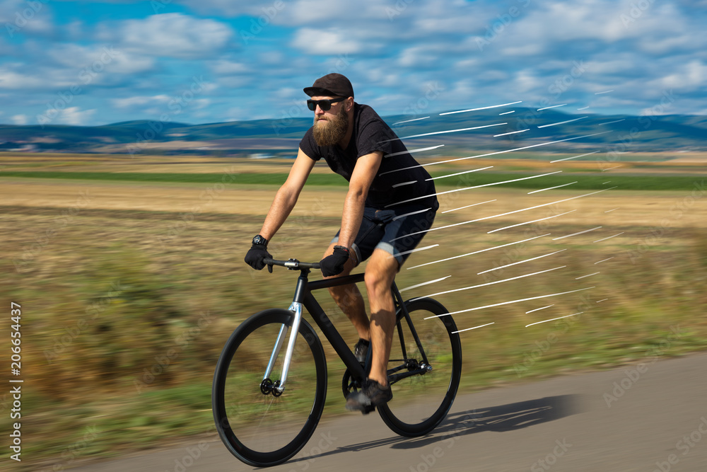 Casual hipster cyclist riding bicycle with high speed concept Casual hipster cyclist riding bicycle with high speed concept