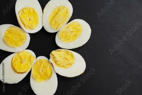 Fotografija Hard Half Boiled Eggs, Sliced in Halves Food Ingredient Preparation Black Backgr