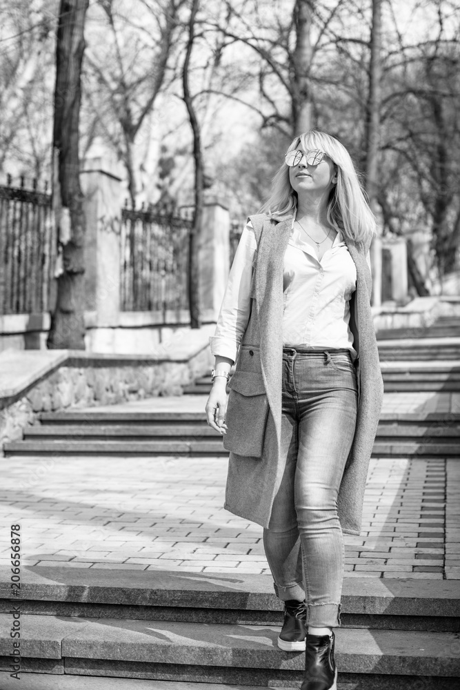 A woman of plus size, American or European appearance walks in the city enjoying life. A young lady with excess weight, xl size at the center of the city. Natural beauty A woman of plus size, American or European appearance walks in the city enjoying life. A young lady with excess weight, xl size at the center of the city. Natural beauty