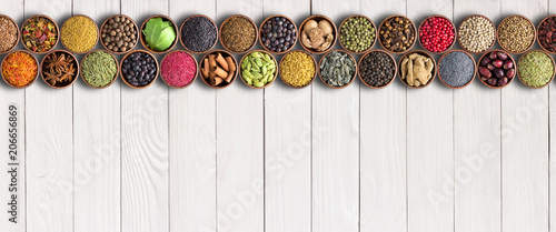 Fototapeta Naklejka Na Ścianę i Meble -  Indian spices in  cups on table with copy space. asian food, seasonings background,  top view.
