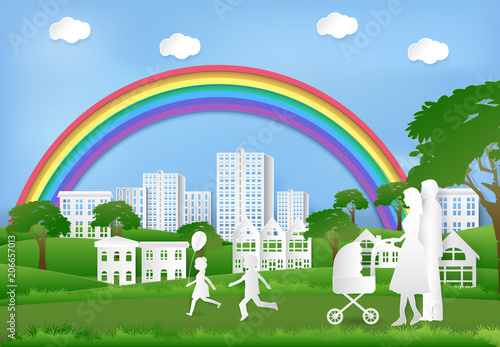 Happy family having fun in the park and rainbow on blue sky, Paper art background