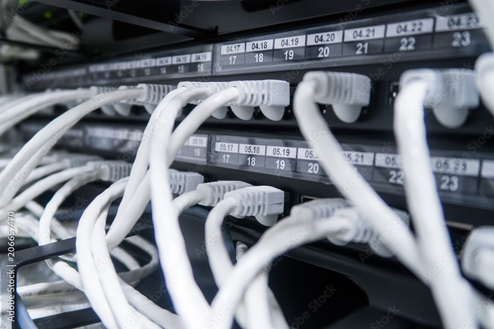 Network cables connected to switch - closeup of data center hardware. Network cables connected to switch - closeup of data center hardware.