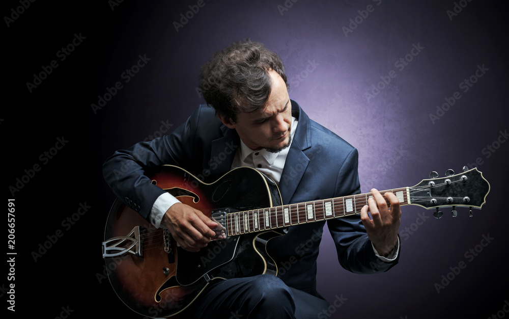 Obraz premium Lonely guitarist composing on cello with nothing around