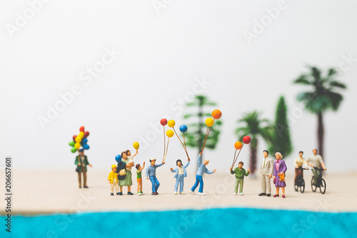 Miniature people : happy family enjoy summer vacation on the beach