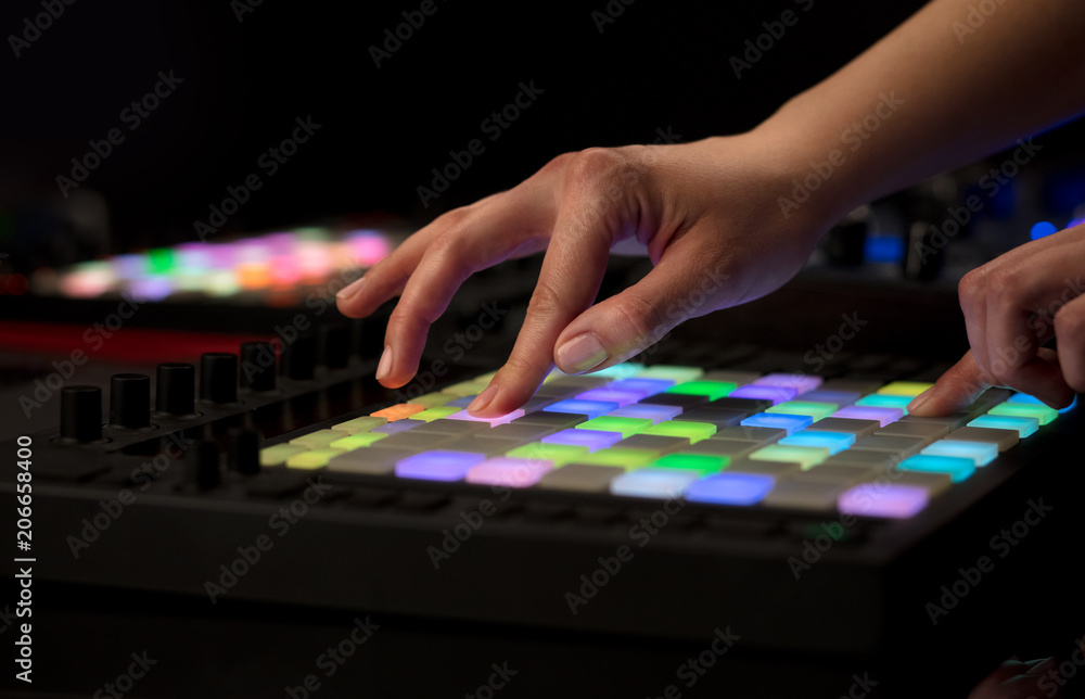 Obraz premium Dj hand remixing music on midi controller 