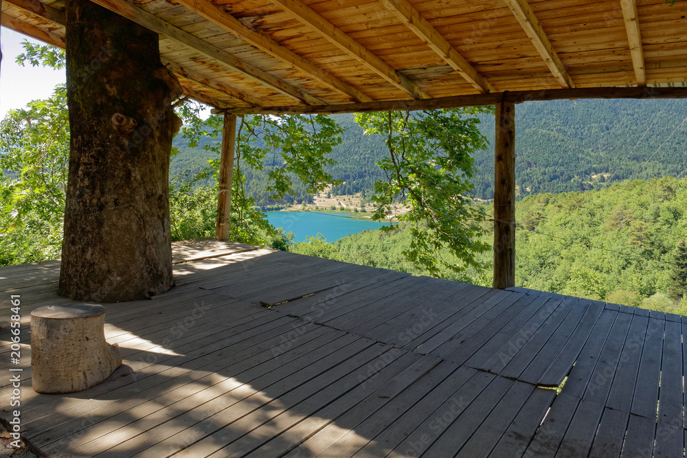view of blue water mountain lake from an old open shed