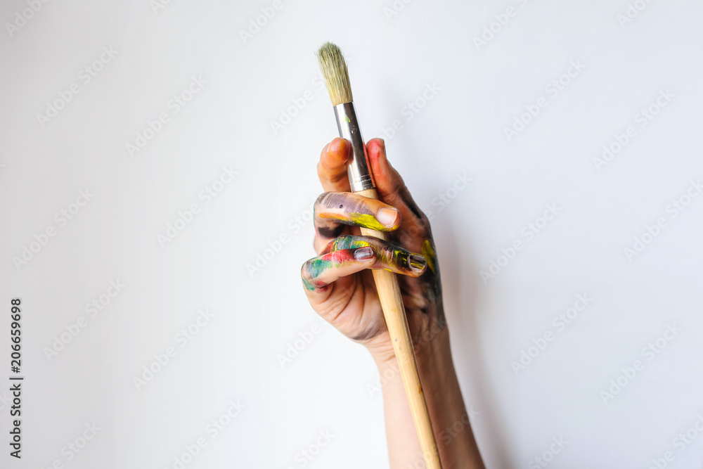 Fototapeta premium Close Up of an artist/painter hands holding paint brushes