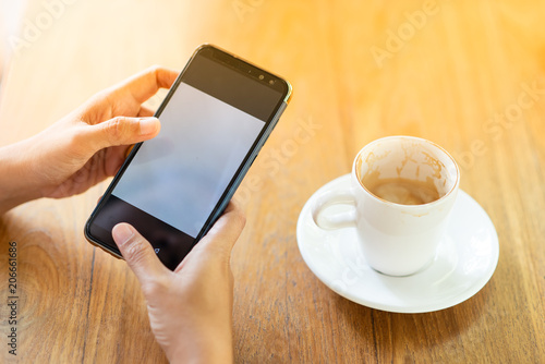 Play the mobile phone and drinking coffee in the morning.