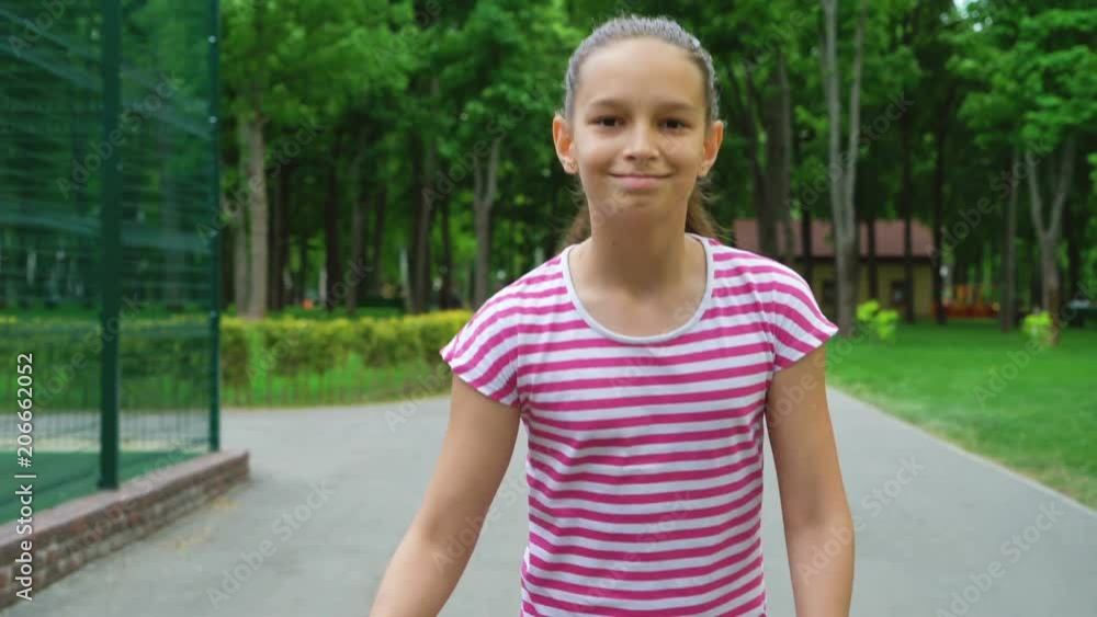 Young girl skateboarding on road in park. moves to success. teenager legs skating. leisure time Young girl skateboarding on road in park. moves to success. teenager legs skating. leisure time