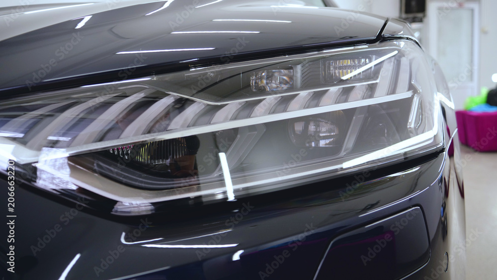 Fototapeta premium Car on a car wash, close-up headlight