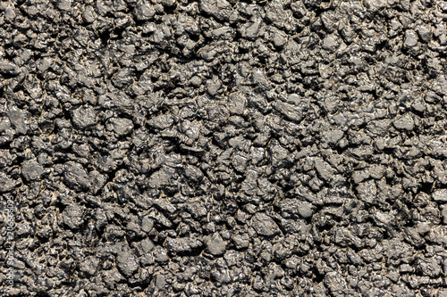 The texture of the roadway is asphalt. Close-up