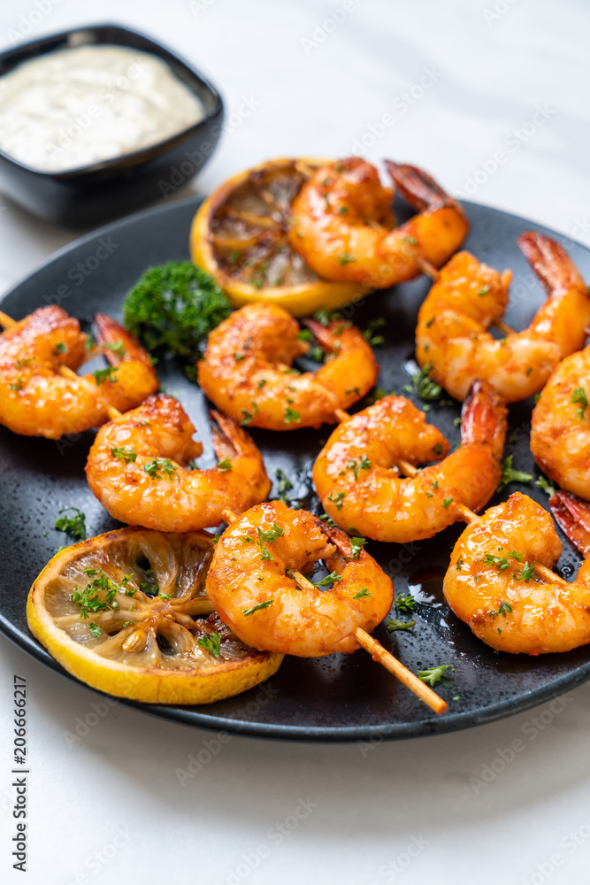 Grilled tiger shrimps skewers with lemon Grilled tiger shrimps skewers with lemon