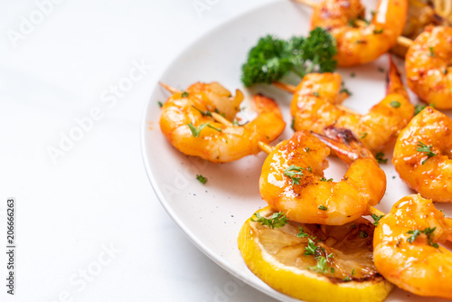Grilled tiger shrimps skewers with lemon © topntp