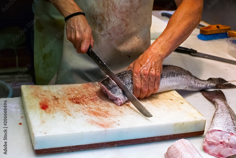 Man cutting fish on fish market Man cutting fish on fish market