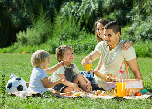 parents with daughters having picnic