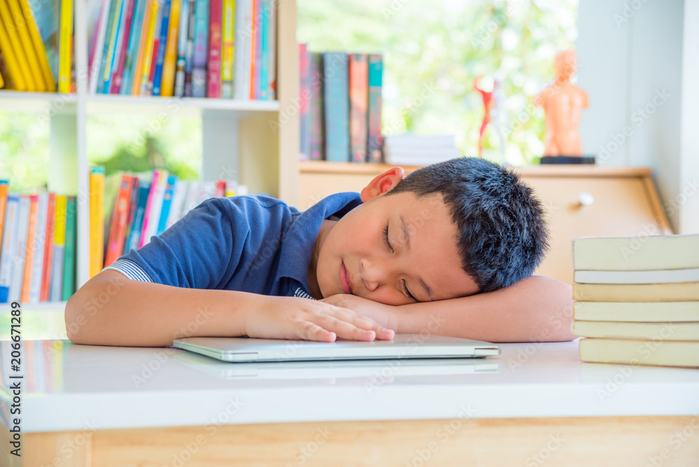 Young asian schoolboy fall asleep in school library Young asian schoolboy fall asleep in school library
