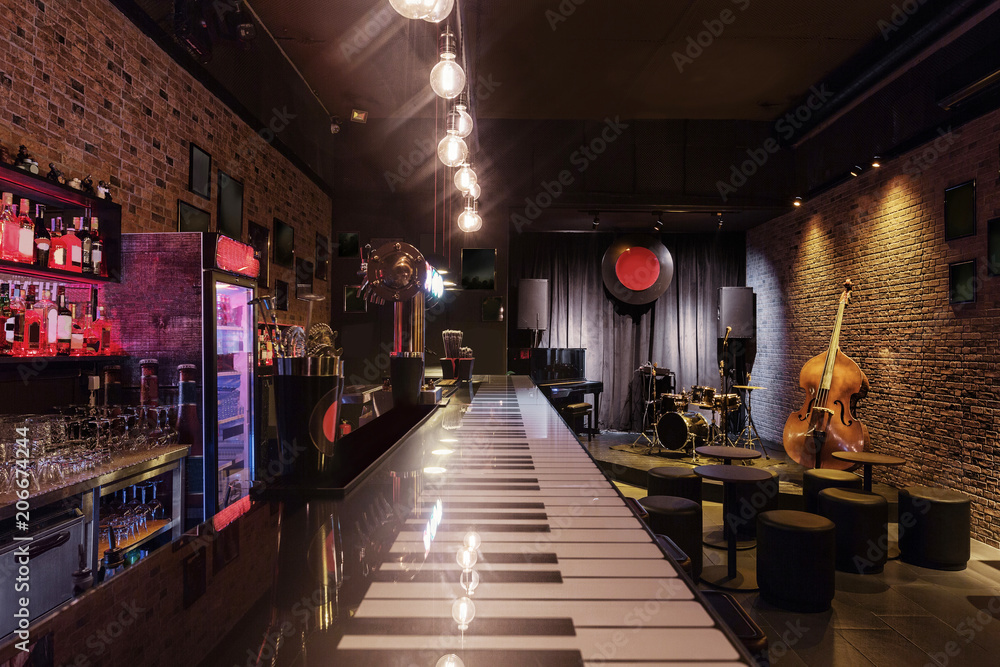 Modern jazz bar interior design, stage with black piano and cello