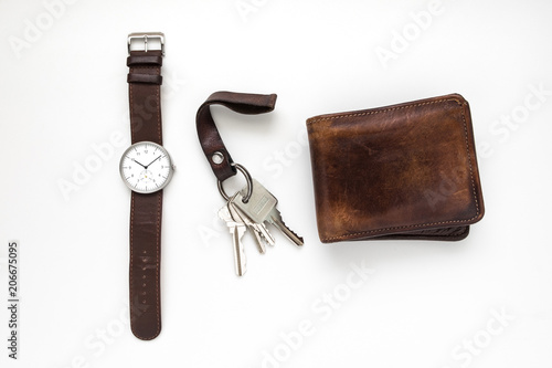Картината върху платно Top view of everyday carry objects made by brown leather wrist watch, key chain,