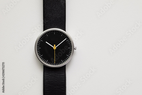 Minimalist wristwatch black dial on white background photo