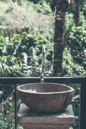 Natural organic stone sink washbasin in the jungle of Bali island. Indonesia.