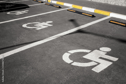 handicap parking in a row, wheelchair parking symbole on asphalt road © Alexey