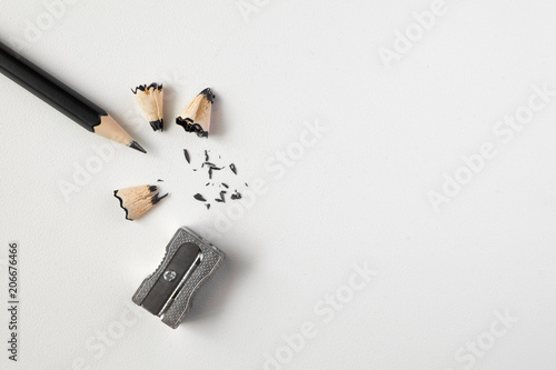 Pencil with sharpening shavings on white background