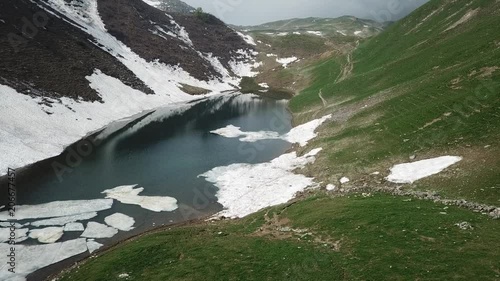 Drone aerial view of the Lake Branchino an Alpine natural lake during spring season. Italian Alps. Italy photo