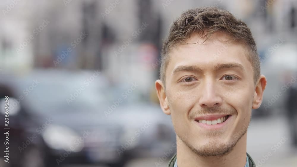 Portrait of smiling Eurasian male looking to camera, in slow motion Portrait of smiling Eurasian male looking to camera, in slow motion