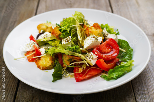 Appetizind fresh vegetable salad with letuce, croutons and feta cheese. Mediterranean food, appetizer, banquet, restaurant menu, dining concept