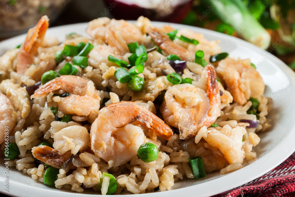 Fried rice with shrimp and vegetables served on a plate Fried rice with shrimp and vegetables served on a plate