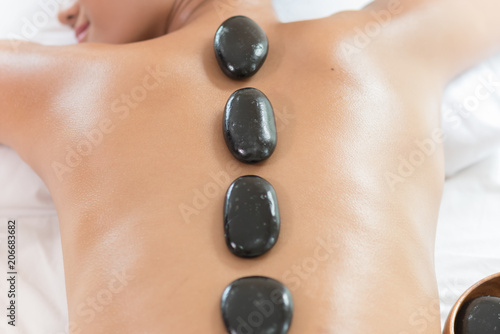 Spa Stone Massage. Young woman getting hot stone massage
