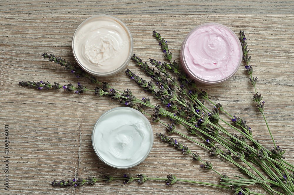 A bunch of lavender displayed with containers of body lotion A bunch of lavender displayed with containers of body lotion
