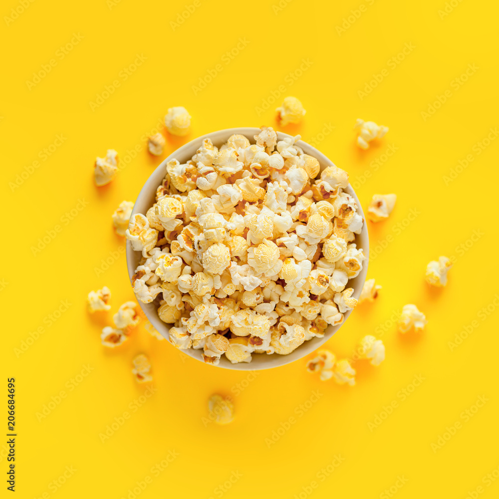 popcorn in paper box on a yellow background, top view popcorn in paper box on a yellow background, top view