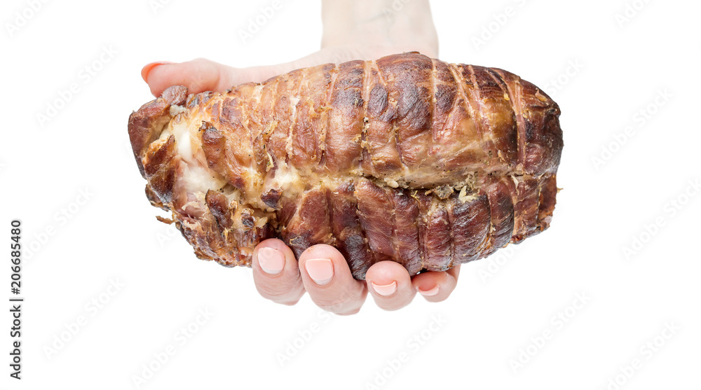 Female's hand holding smoked ham. Close up. Isolated on white.
