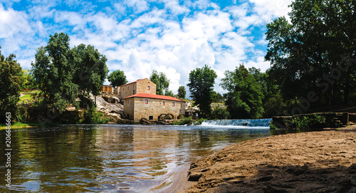 Panoramic view of the river Coura and a water mill. River beach of Vilar de Mouros, Portugal photo