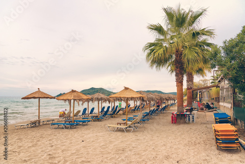 Alikanas  Zakynthos Island  Greece     September 28  2017  Sunbeds  umbrellas and palms on the Alikanas beach  Zakynthos Island  Greece.