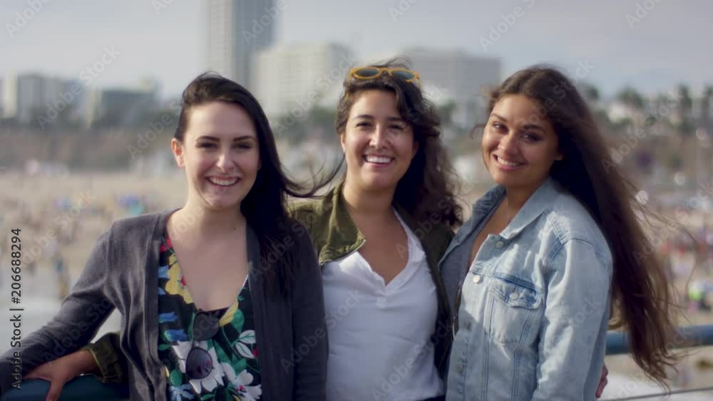Portrait Of Smiling Friends On Santa Monica Pier, They Laugh And Chat (Shot On Red Scarlet-W Dragon In 4K, Slow Motion) Portrait Of Smiling Friends On Santa Monica Pier, They Laugh And Chat (Shot On Red Scarlet-W Dragon In 4K, Slow Motion)