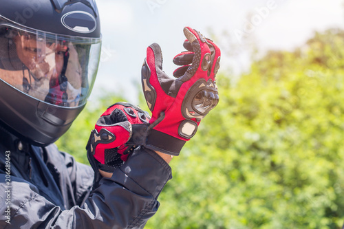 Man in a Motorcycle with helmet and gloves is an important protective clothing for motorcycling throttle control,safety concept